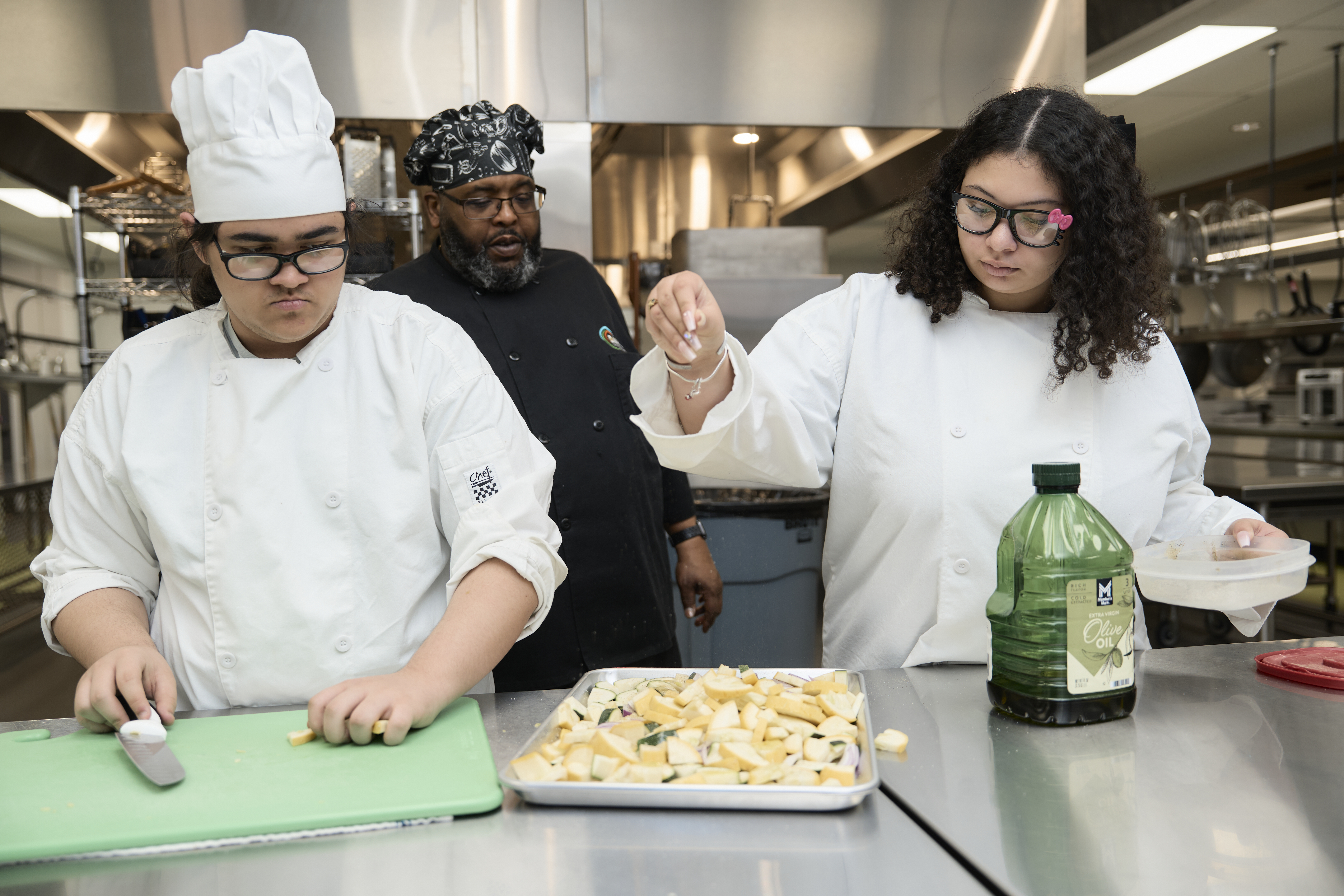 Culinary arts students working with chef.